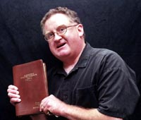 Pastor Kelley holding a bible